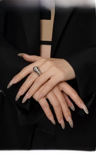 Detailed view of silver chrysalis textured ring on model hand with minimalist style