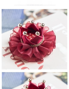Macro shot of elegant burgundy crown hairpiece with satin ribbon and organza detail