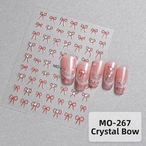 Detailed view of 5D red bow nail stickers with rhinestone accents and glitter nail art