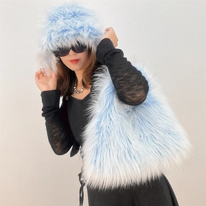 Close-up of soft light blue and white gradient faux fur hat and matching handbag set