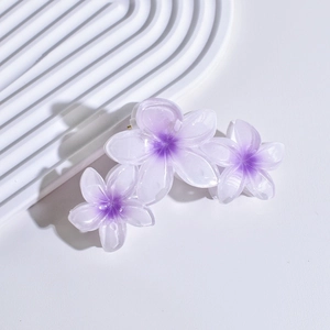 Detail of elegant white and purple gradient flower hair claw clip with glossy finish