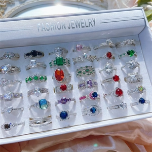 Detailed set of fashion rings with colorful cubic zirconia in a white display case