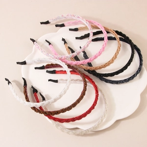 Sparkling crystal beaded headbands in various colors on a white decorative petal tray