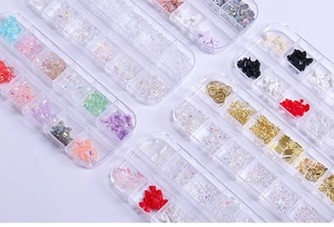 Detailed macro view of 12-slot storage box with colorful resin bows and nail art gems