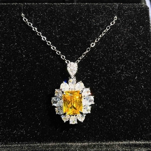 Macro view of Asscher cut yellow gemstone necklace in a luxury black jewelry box