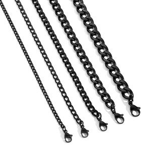 Detail of five black Cuban link chains in varying widths with lobster clasps on white background