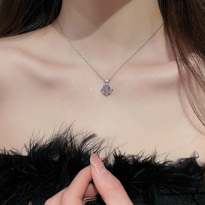 Close-up of a 14k gold plated necklace featuring a pink zircon rose flower pendant