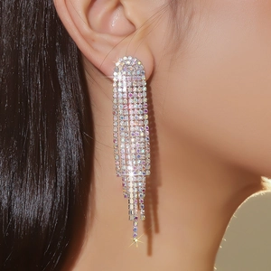 Close-up of long tassel rhinestone earrings on model showing silver sparkling crystals