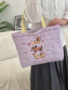 Purple quilted tote bag with cute cartoon dog embroidery and bright yellow handles