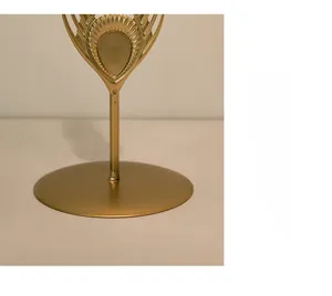 Close-up of a wide gold metal candle holder base with stable plating and smooth finish