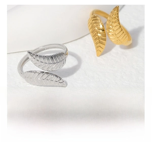 Detail of leaf design stainless steel open rings in gold and silver finish