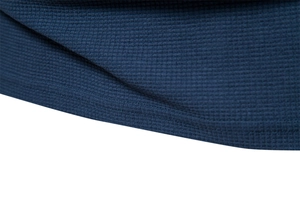 Macro shot of dark blue waffle knit fabric texture and high-quality stitching detail