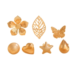 Detail of 7-piece gold ear cuff set featuring star, heart, flower and leaf shapes