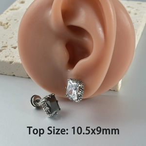 Vintage claw-set zircon stud earrings in black and white on a model ear, size 10.5x9mm