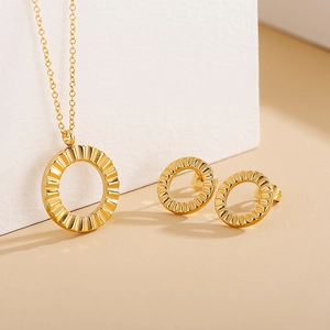 Golden ripple pendant necklace and matching stud earrings set on minimalist geometric background