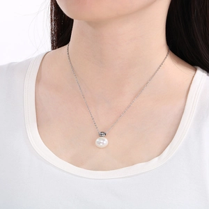 Elegant silver chain necklace featuring a round white shell pearl pendant on model