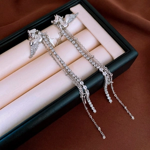 Detail of silver Pegasus tassel earrings with shimmering crystals and stars