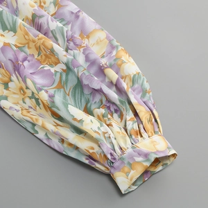 Detailed macro view of the floral printed sleeve cuff on a sexy summer dress