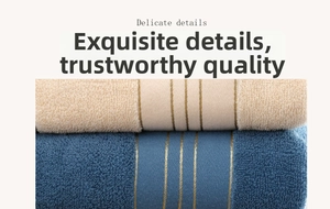 Close-up of fluffy cotton towel showing elegant golden metallic satin stripe details
