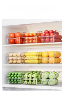 Stackable transparent kitchen drawer storage showing assorted fresh vegetables and fruits