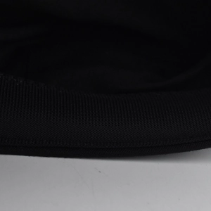 Macro detail of high-quality black twill fabric stitching on a vintage beret hat