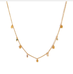 Close-up of golden necklace with geometric squares and colorful translucent beads