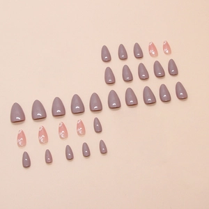Lilac almond press-on nails with white floral patterns on a smooth glossy surface