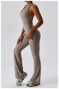 Detail view of v-neck jumpsuit with flared leg and slim fit in taupe grey color