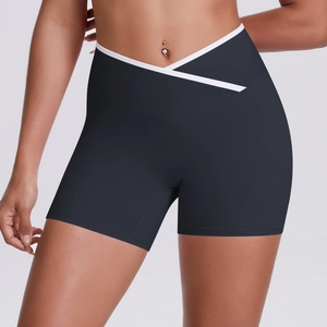 Detail of high-waist yoga shorts with V-cross waistband and white contrast piping