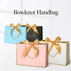 Elegant gift bags with satin bowknot and golden rope handles in multiple colors