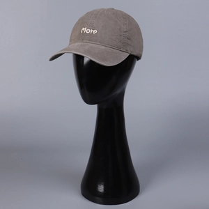Close-up of more embroidery on gray washed cotton baseball cap with curved brim detail