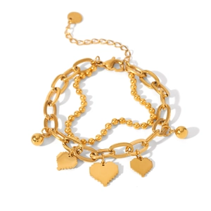 Detail view of gold layered chain bracelet with pixel heart charms and polished beads