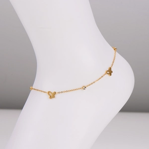 Elegant gold stainless steel butterfly anklet with sparkling crystal charms on a model ankle