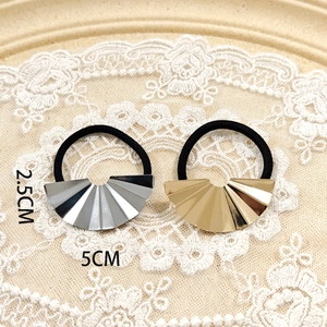 Macro view of gold and silver pleated fan-shaped metal hair cuffs with size dimensions