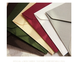 Detail of vintage linen texture envelopes in multiple colors on retro musical paper background