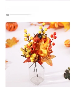 Detailed view of autumn flower arrangement with maple leaves and berries in a glass vase
