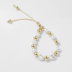 Adjustable two-tone beaded bracelet with gold metal beads, white pearls, and heart charms