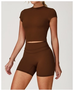 Close-up of coffee brown cropped yoga top and high-waisted fitness shorts with soft texture