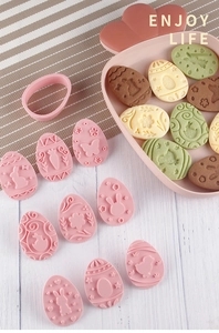 Detail of 9-piece Easter cookie molds featuring rabbit and egg patterns on dough