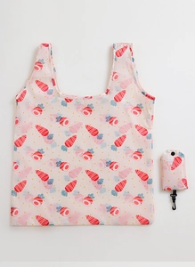 Detail of pink folding shopping bag with red carrot print and hanging storage pouch