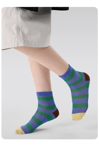 Detail of breathable mesh knit texture on colorful striped crew socks for children