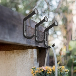 Set of 3 vintage industrial cast iron wall hooks with a rustic black matte finish