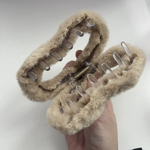 Detail of plush brown claw clip showing soft faux fur texture and strong metal spring