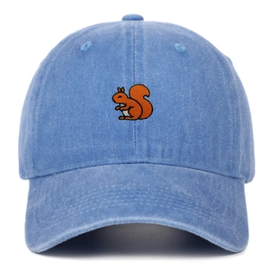 Close-up detail of squirrel embroidery on a light blue washed cotton baseball cap
