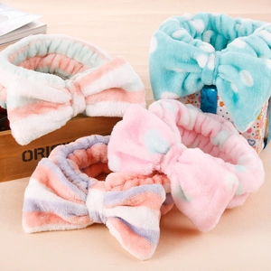 Multiple coral fleece bow headbands in leopard and striped patterns for skincare