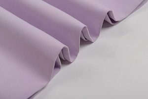 Detailed macro view of lavender purple smooth fabric texture with soft wavy drapes