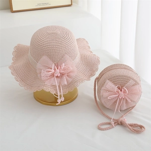 Detailed view of pink straw hat and round bag set with lace trim and bow for girls