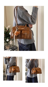 Detail of brown glossy pillow bag featuring front pockets and Y2K aesthetic style