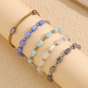 Stack of 18K gold plated stainless steel handmade glass beaded bracelets in five colors