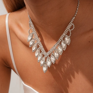 Close-up of V-shaped silver fringe necklace with marquise cut crystals on model